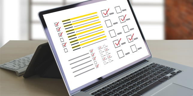 Close-up of a laptop screen showing a document of highlighted information and several filled-in check boxes. 